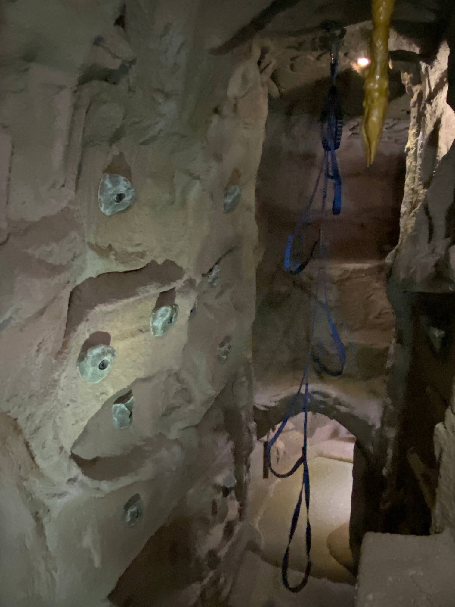 Rock climbing holds are made of recycled bottles and allow visitors to explore three levels. Soft flooring protects visitors while climbing.